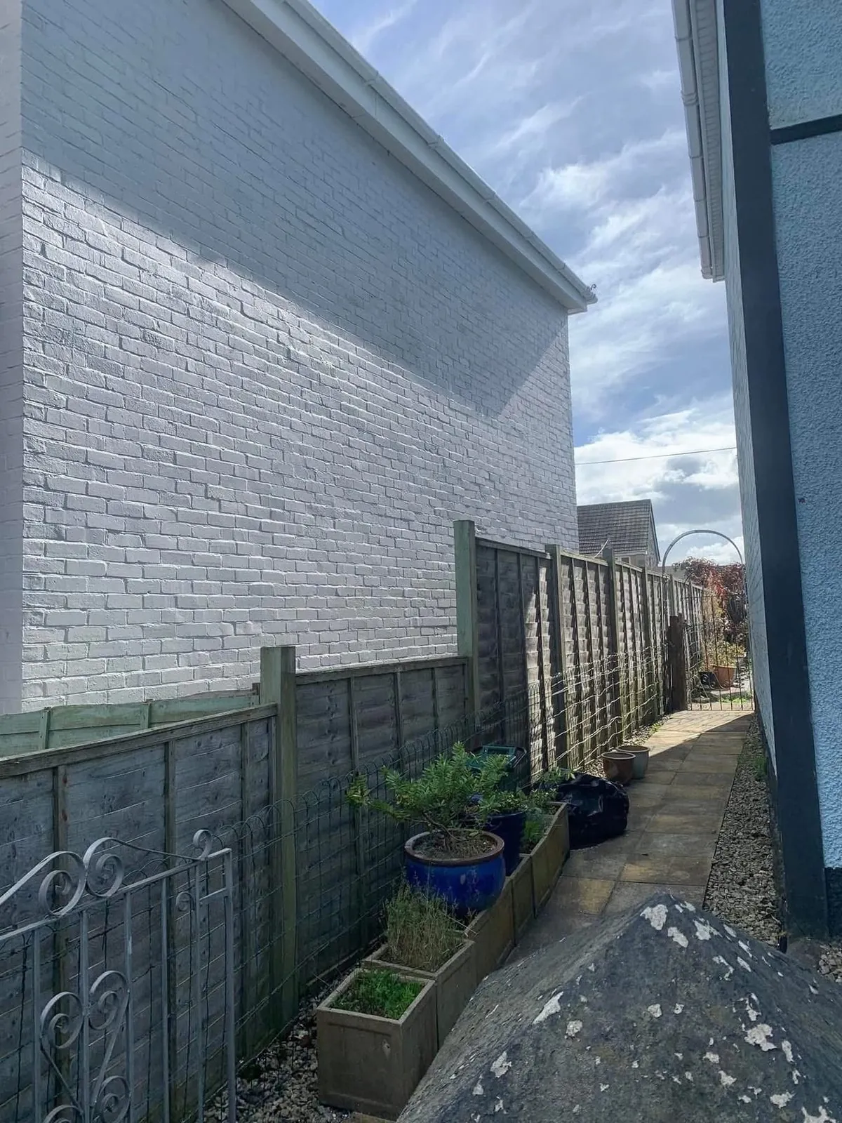 Freshly painted brick wall after preparation and masonry paint in Brixham